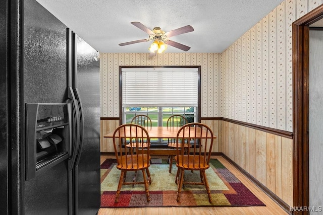 5241 County Road 48th Rd, Jemison, AL 35085 - dining room with wallpapered walls, wainscoting, ceiling fan, a textured ceiling, and wood finished floors