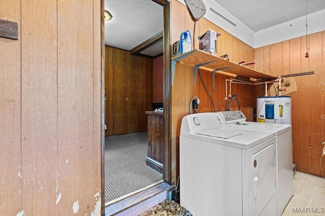 5241 County Road 48th Rd, Jemison, AL 35085 - laundry area with wood walls, washing machine and clothes dryer, a textured ceiling, and water heater