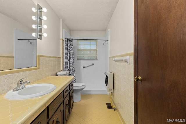 5241 County Road 48th Rd, Jemison, AL 35085 - bathroom with tile walls, heating unit, toilet, a wainscoted wall, and vanity