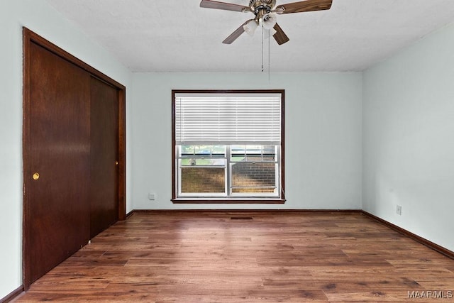 5241 County Road 48th Rd, Jemison, AL 35085 - unfurnished bedroom featuring a closet, wood finished floors, baseboards, and ceiling fan