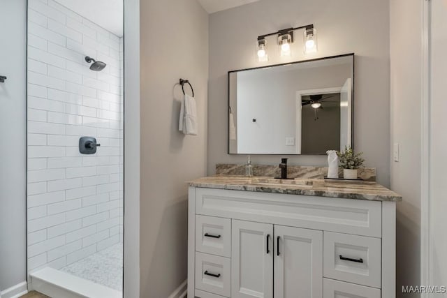 302 Janice St, Prattville, AL 36066 - bathroom with a tile shower, vanity, ceiling fan, and baseboards