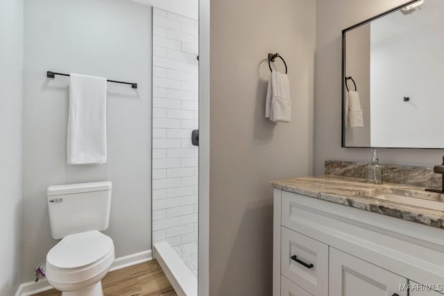 302 Janice St, Prattville, AL 36066 - full bathroom featuring vanity, toilet, a tile shower, baseboards, and wood finished floors