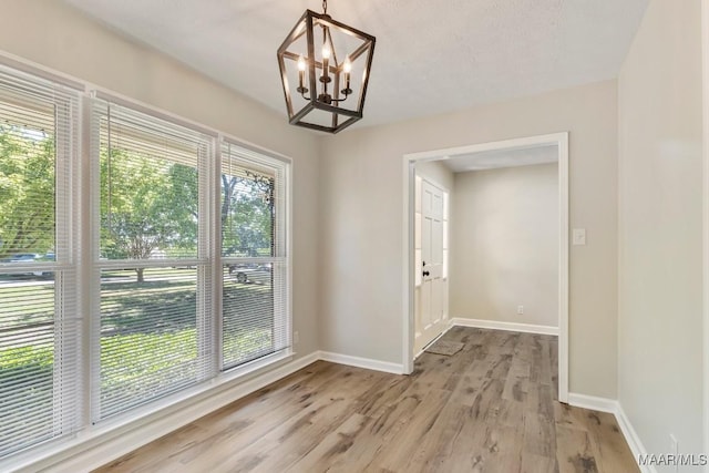 302 Janice St, Prattville, AL 36066 - unfurnished dining area featuring a chandelier, baseboards, and light wood-type flooring