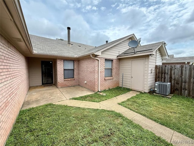 6260 Bell Gables Cir, Montgomery, AL 36117 - back of property with central AC, brick siding, a patio area, and roof with shingles