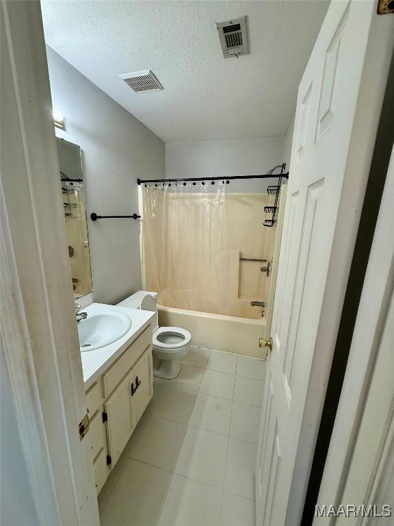 6260 Bell Gables Cir, Montgomery, AL 36117 - full bathroom with toilet, vanity, shower / bath combo, a textured ceiling, and tile patterned flooring
