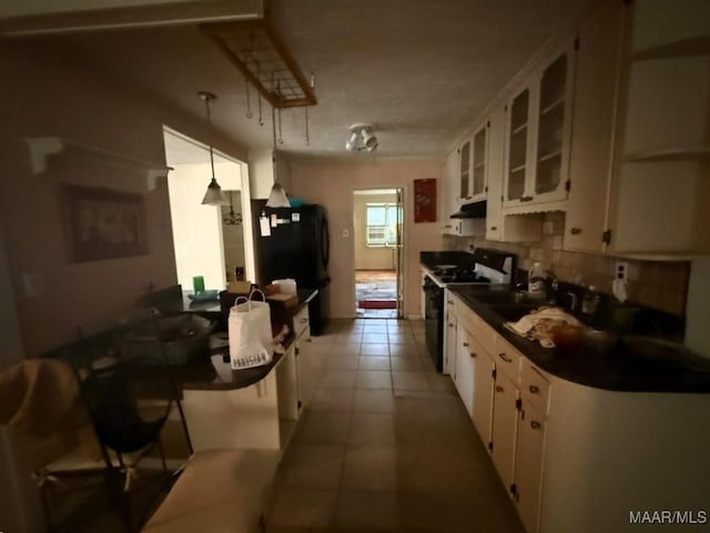 2700 W Edgemont Ave, Montgomery, AL 36108 - kitchen with dark countertops, black appliances, white cabinetry, and a sink