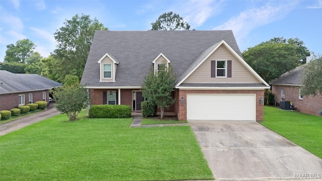 8945 Chantilly Way, Montgomery, AL 36116 - view of front of property featuring a front lawn, driveway, an attached garage, central AC unit, and a shingled roof