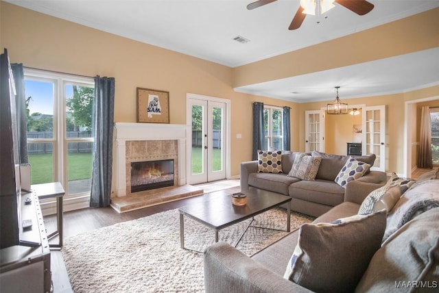 8945 Chantilly Way, Montgomery, AL 36116 - living room with wood finished floors, ornamental molding, healthy amount of natural light, a tile fireplace, and a ceiling fan