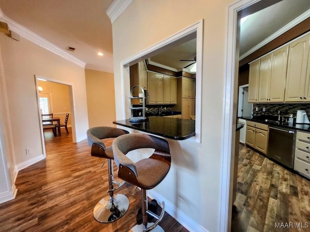 103 River Chase Ct, Wetumpka, AL 36092 - kitchen with dishwasher, ornamental molding, dark countertops, a breakfast bar, and backsplash