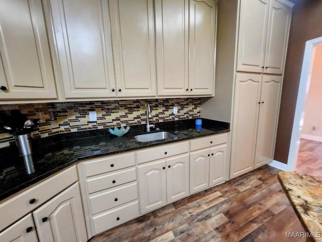 103 River Chase Ct, Wetumpka, AL 36092 - kitchen with a sink, wood finished floors, tasteful backsplash, white cabinetry, and dark stone counters