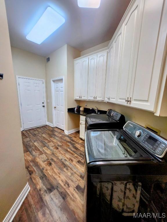 103 River Chase Ct, Wetumpka, AL 36092 - laundry area with washing machine and dryer, cabinet space, dark wood-style flooring, and baseboards