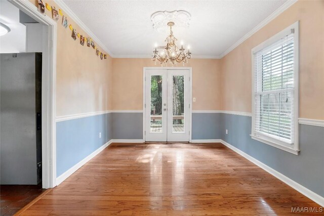184 Fox Hollow Rd, Montgomery, AL 36109 - unfurnished dining area with a chandelier, wood finished floors, french doors, ornamental molding, and baseboards
