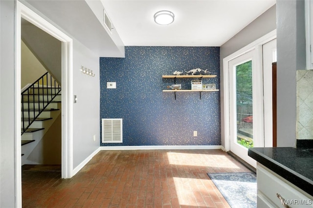 184 Fox Hollow Rd, Montgomery, AL 36109 - dining area featuring stairs, wallpapered walls, brick floors, and baseboards