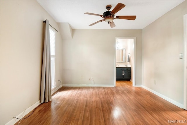 184 Fox Hollow Rd, Montgomery, AL 36109 - unfurnished bedroom featuring light wood-style flooring, baseboards, connected bathroom, and a ceiling fan