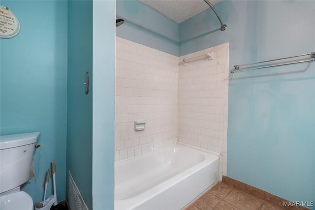 184 Fox Hollow Rd, Montgomery, AL 36109 - bathroom featuring toilet, shower / washtub combination, a textured ceiling, tile patterned flooring, and baseboards