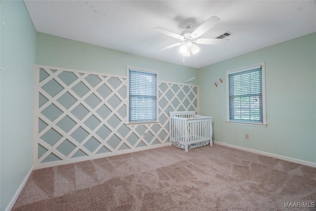 184 Fox Hollow Rd, Montgomery, AL 36109 - unfurnished bedroom with multiple windows, carpet flooring, baseboards, and ceiling fan
