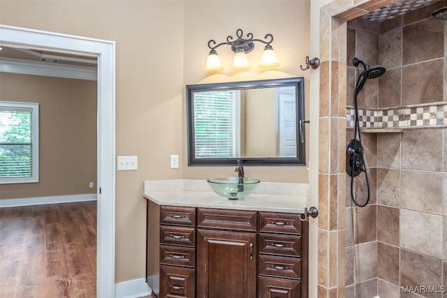 8460 Rockbridge Cir, Montgomery, AL 36116 - bathroom with tiled shower, vanity, ornamental molding, wood finished floors, and baseboards