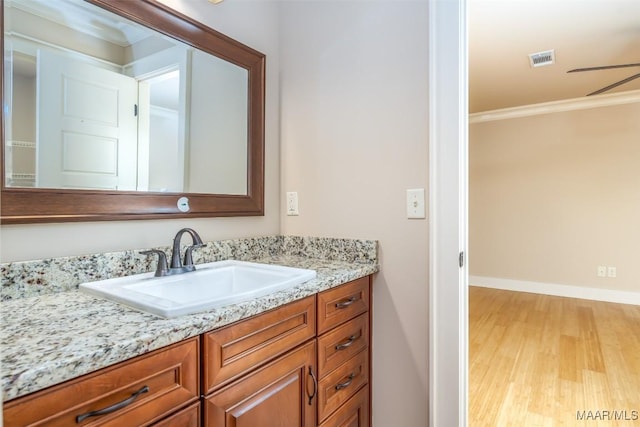 8460 Rockbridge Cir, Montgomery, AL 36116 - bathroom with wood finished floors, ornamental molding, vanity, and baseboards