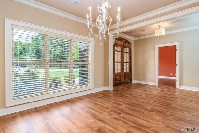 8460 Rockbridge Cir, Montgomery, AL 36116 - spare room with a chandelier, healthy amount of natural light, crown molding, wood finished floors, and baseboards