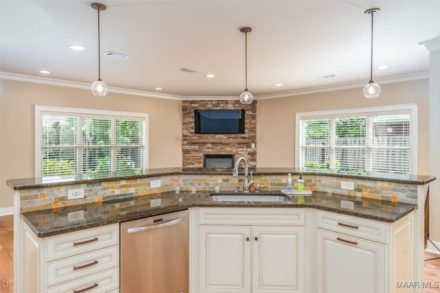 8460 Rockbridge Cir, Montgomery, AL 36116 - kitchen featuring dishwasher, a sink, crown molding, dark stone countertops, and decorative light fixtures