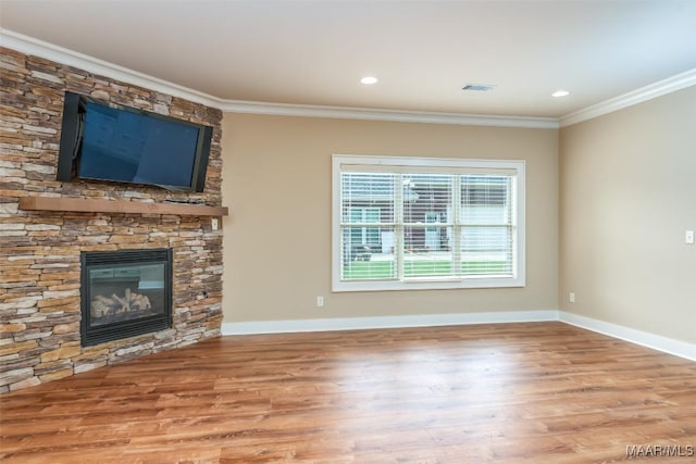 8460 Rockbridge Cir, Montgomery, AL 36116 - unfurnished living room featuring wood finished floors, ornamental molding, a stone fireplace, baseboards, and recessed lighting