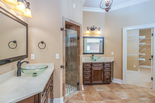 8460 Rockbridge Cir, Montgomery, AL 36116 - bathroom featuring a stall shower, ornamental molding, two vanities, baseboards, and a walk in closet