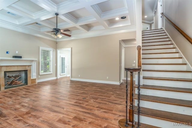 8460 Rockbridge Cir, Montgomery, AL 36116 - unfurnished living room featuring ceiling fan, wood finished floors, a tile fireplace, coffered ceiling, and baseboards