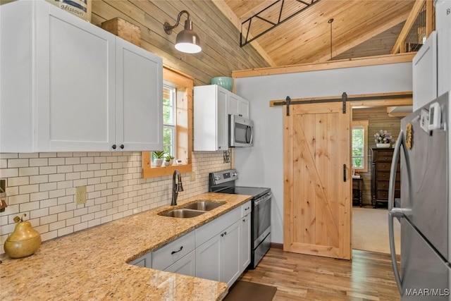 13871 Old Pike Rd, Mathews, AL 36052 - kitchen with stainless steel appliances, a sink, a barn door, plenty of natural light, and wooden ceiling