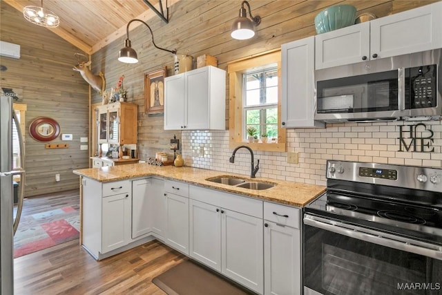 13871 Old Pike Rd, Mathews, AL 36052 - kitchen featuring appliances with stainless steel finishes, a sink, wooden walls, wood ceiling, and vaulted ceiling