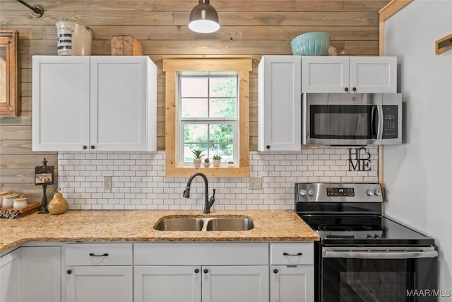 13871 Old Pike Rd, Mathews, AL 36052 - kitchen featuring appliances with stainless steel finishes, a sink, white cabinets, decorative backsplash, and light stone counters