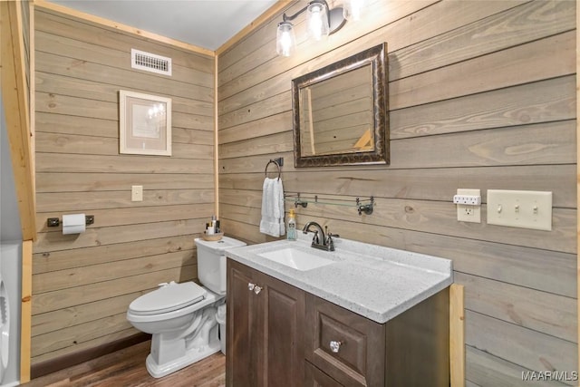 13871 Old Pike Rd, Mathews, AL 36052 - bathroom with vanity, wooden walls, toilet, and wood finished floors