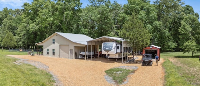 13871 Old Pike Rd, Mathews, AL 36052 - view of front facade with a detached carport, a front lawn, and an outbuilding