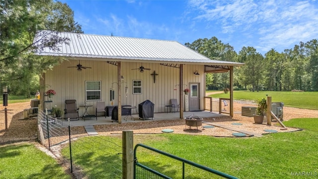13871 Old Pike Rd, Mathews, AL 36052 - rear view of house featuring a ceiling fan, a patio area, a lawn, and metal roof
