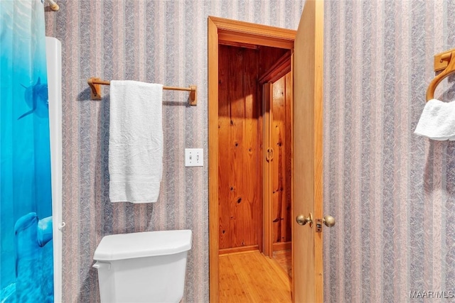 300 Elmore Rd, Titus, AL 36080 - bathroom featuring wood finished floors, toilet, and wallpapered walls