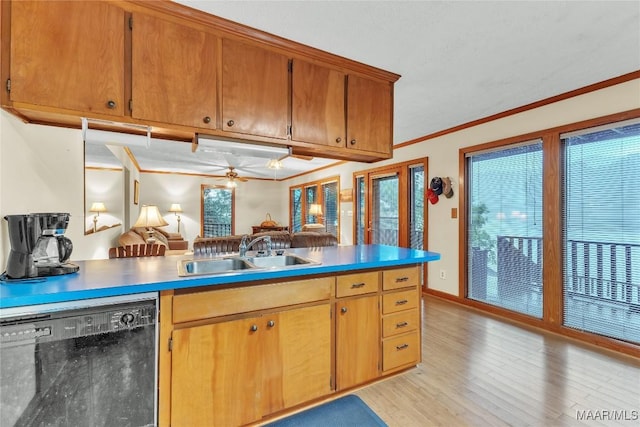 300 Elmore Rd, Titus, AL 36080 - kitchen featuring black dishwasher, a sink, light wood-type flooring, ornamental molding, and a peninsula