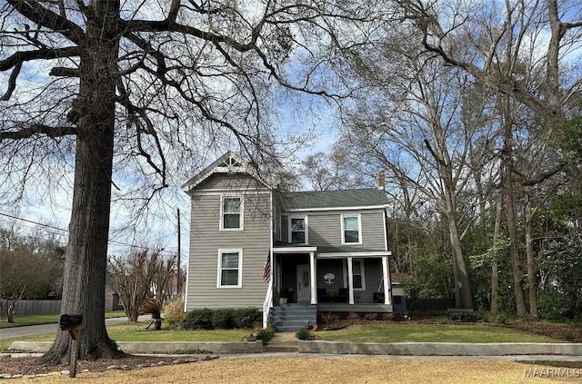 408 W Tuskeena St, Wetumpka, AL 36092 - view of front of home with covered porch and a front lawn