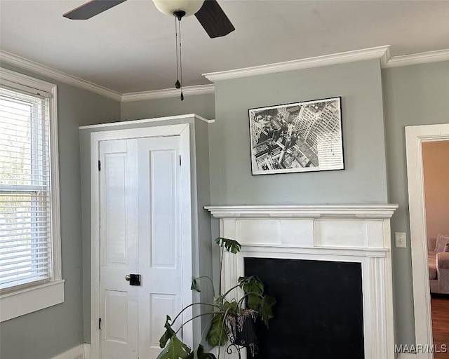 408 W Tuskeena St, Wetumpka, AL 36092 - foyer with a ceiling fan, crown molding, a fireplace, baseboards, and wood finished floors