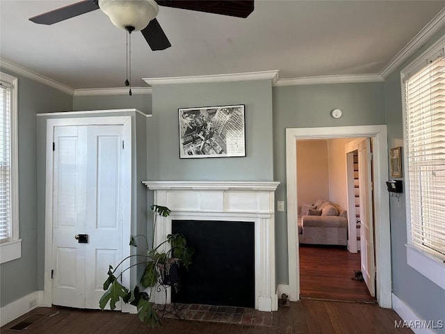 408 W Tuskeena St, Wetumpka, AL 36092 - living room with wood-type flooring, ornamental molding, baseboards, ceiling fan, and a fireplace with flush hearth