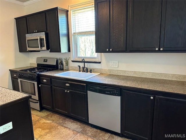408 W Tuskeena St, Wetumpka, AL 36092 - kitchen with stainless steel appliances, a sink, crown molding, and dark cabinetry