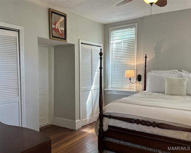 408 W Tuskeena St, Wetumpka, AL 36092 - bedroom featuring dark wood-type flooring, baseboards, a textured ceiling, ceiling fan, and multiple closets