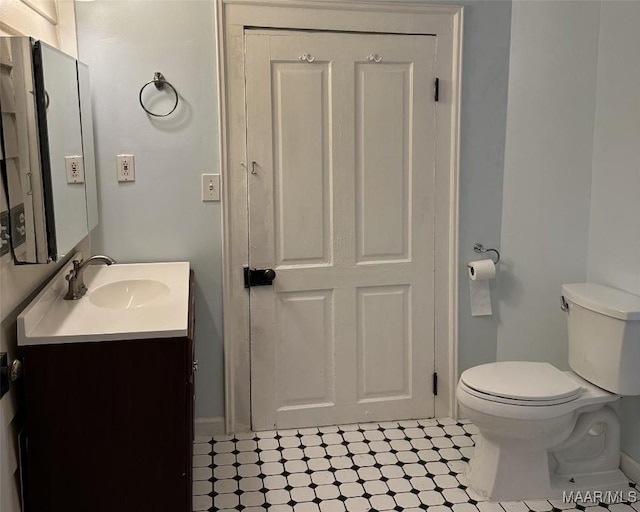 408 W Tuskeena St, Wetumpka, AL 36092 - bathroom featuring vanity, toilet, tile patterned floors, and baseboards