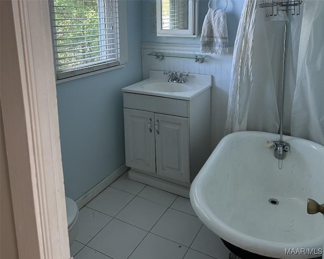 408 W Tuskeena St, Wetumpka, AL 36092 - full bathroom with a freestanding tub, toilet, vanity, tile patterned floors, and baseboards