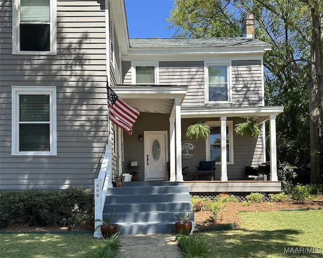 408 W Tuskeena St, Wetumpka, AL 36092 - property entrance featuring a chimney, covered porch, and a yard