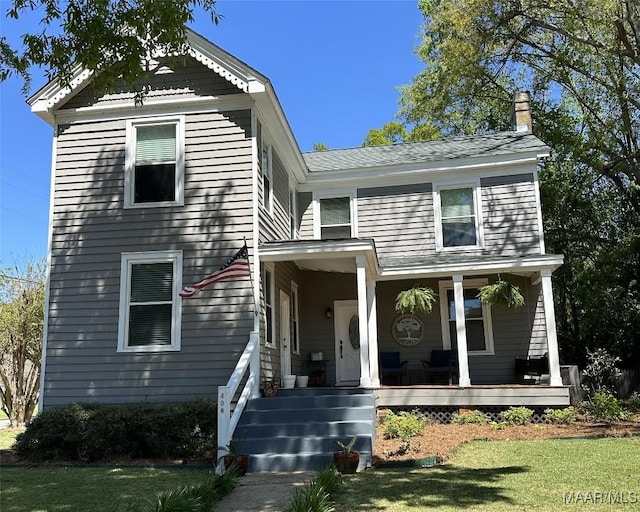 408 W Tuskeena St, Wetumpka, AL 36092 - view of front of home featuring a chimney, a porch, and a front yard