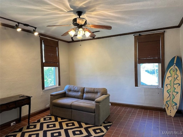 408 W Tuskeena St, Wetumpka, AL 36092 - sitting room featuring dark tile patterned floors, ceiling fan, plenty of natural light, ornamental molding, and baseboards