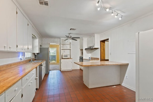 3158 Partridge Ln, Montgomery, AL 36111 - kitchen featuring white appliances, under cabinet range hood, white cabinets, crown molding, and a sink