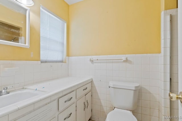3158 Partridge Ln, Montgomery, AL 36111 - bathroom with tile walls, toilet, a wainscoted wall, and vanity