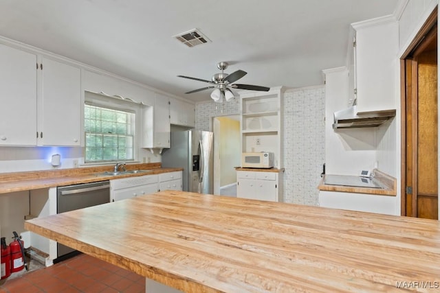 3158 Partridge Ln, Montgomery, AL 36111 - kitchen with stainless steel appliances, a sink, a ceiling fan, white cabinets, and tile patterned floors