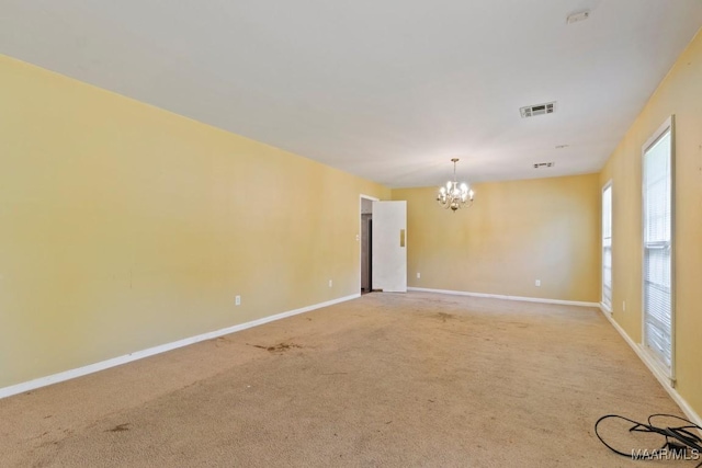 3158 Partridge Ln, Montgomery, AL 36111 - empty room featuring a chandelier, baseboards, and light colored carpet