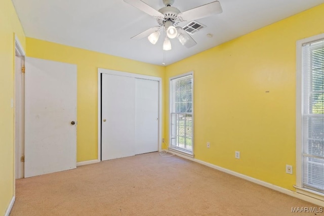 3158 Partridge Ln, Montgomery, AL 36111 - unfurnished bedroom with light colored carpet, multiple windows, baseboards, and a closet